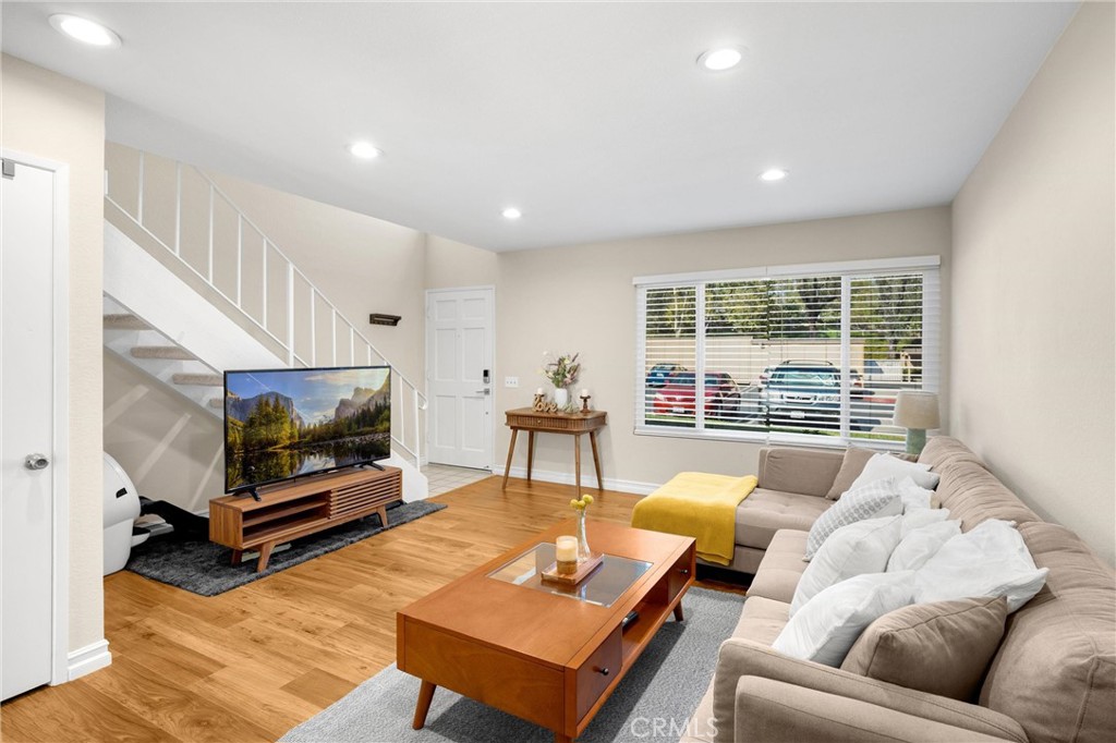 25885 Trabuco Road, Unit 306 Lake Forest, CA 92630 - Photo 6 of 38 a living room with furniture a flat screen tv and a large window