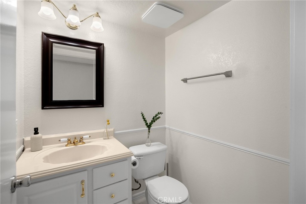 25885 Trabuco Road, Unit 306 Lake Forest, CA 92630 - Photo 8 of 38 a bathroom with a toilet sink and mirror