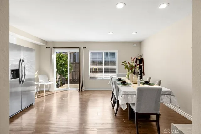 a dining room with furniture and wooden floor
