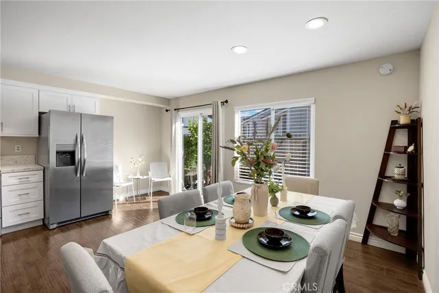 a living room with furniture a large window and wood floor