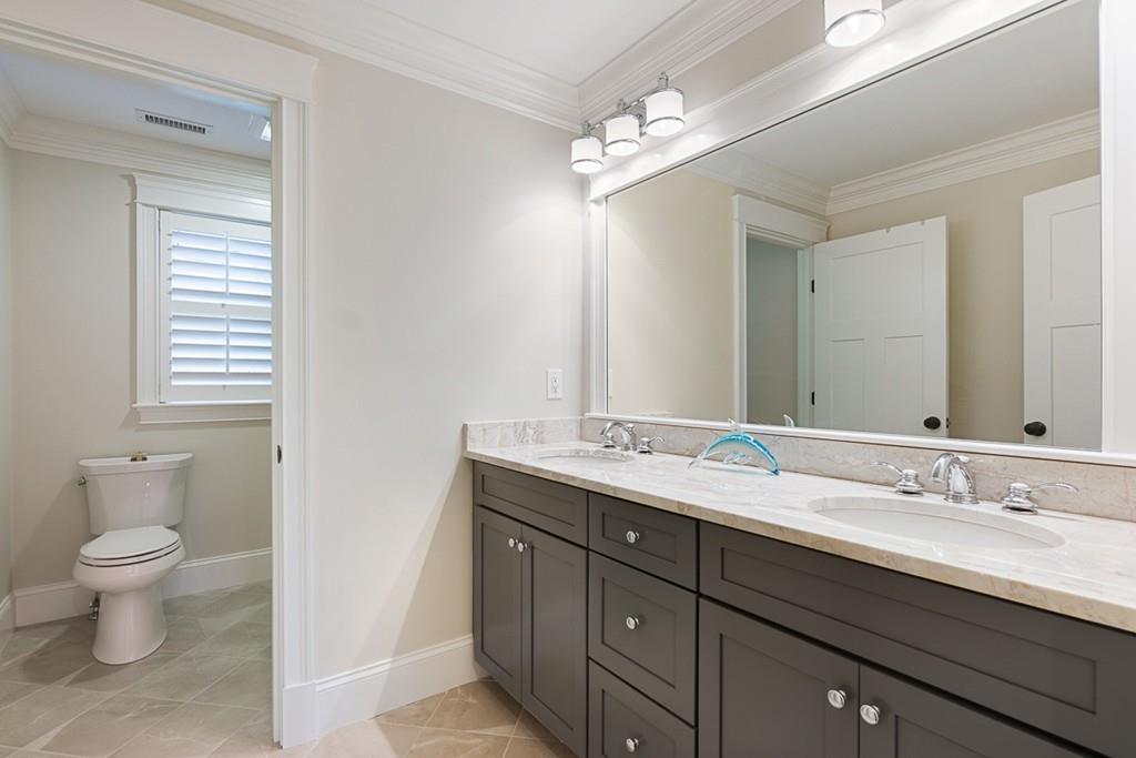 88 Hugh Cargill Road Concord, MA 01742 - Photo 21 of 36 a spacious bathroom with a granite countertop sink a toilet and a mirror
