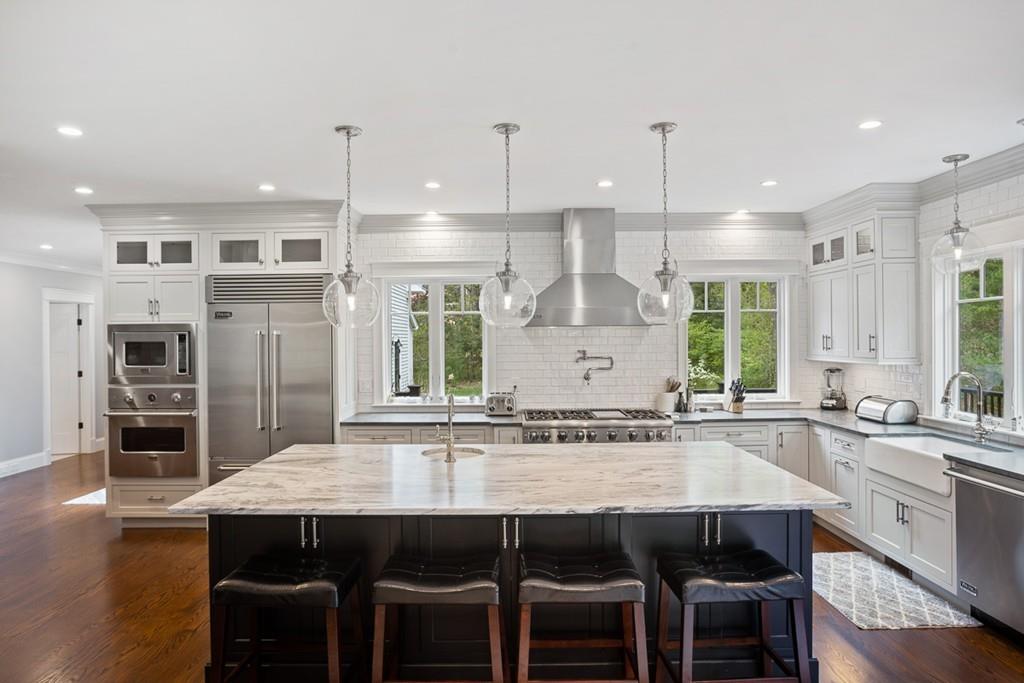 88 Hugh Cargill Road Concord, MA 01742 - Photo 5 of 36 a kitchen with stainless steel appliances granite countertop a kitchen island a stove and a refrigerator
