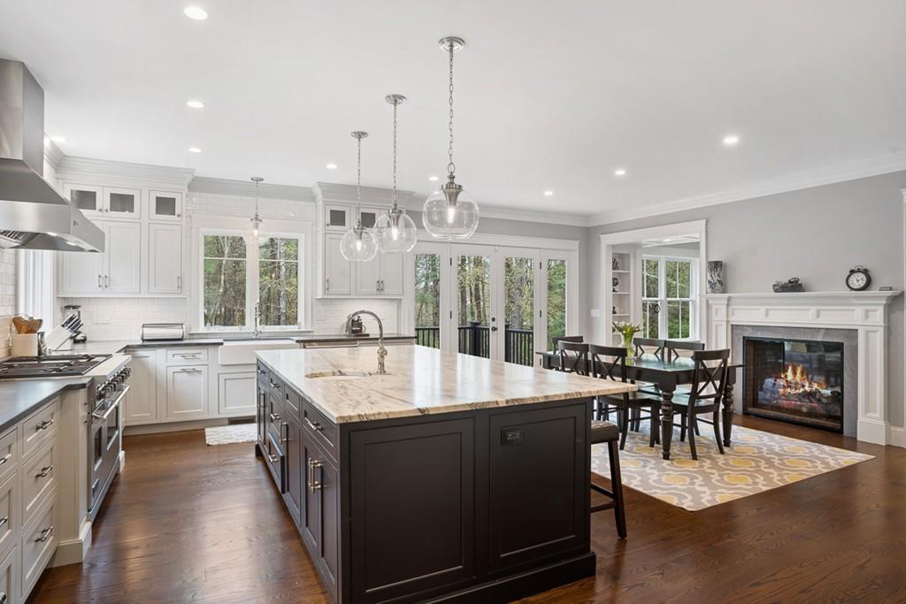 88 Hugh Cargill Road Concord, MA 01742 - Photo 6 of 36 a large kitchen with kitchen island a sink dining table and chairs