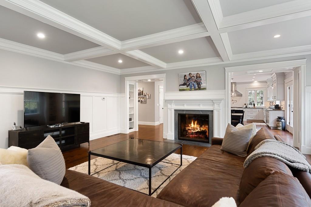 88 Hugh Cargill Road Concord, MA 01742 - Photo 10 of 36 a living room with furniture a flat screen tv and a fireplace
