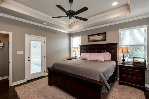 a bedroom with a bed and a ceiling fan