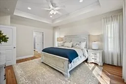 a spacious bedroom with a bed and a chandelier