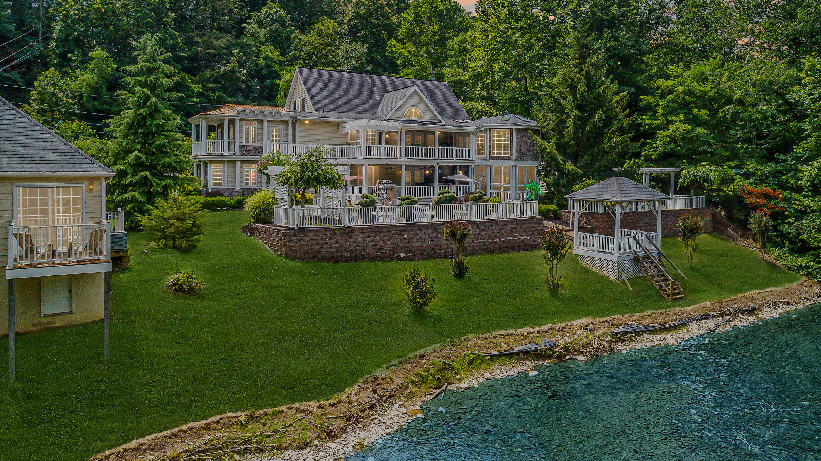 a front view of a house with a garden and plants