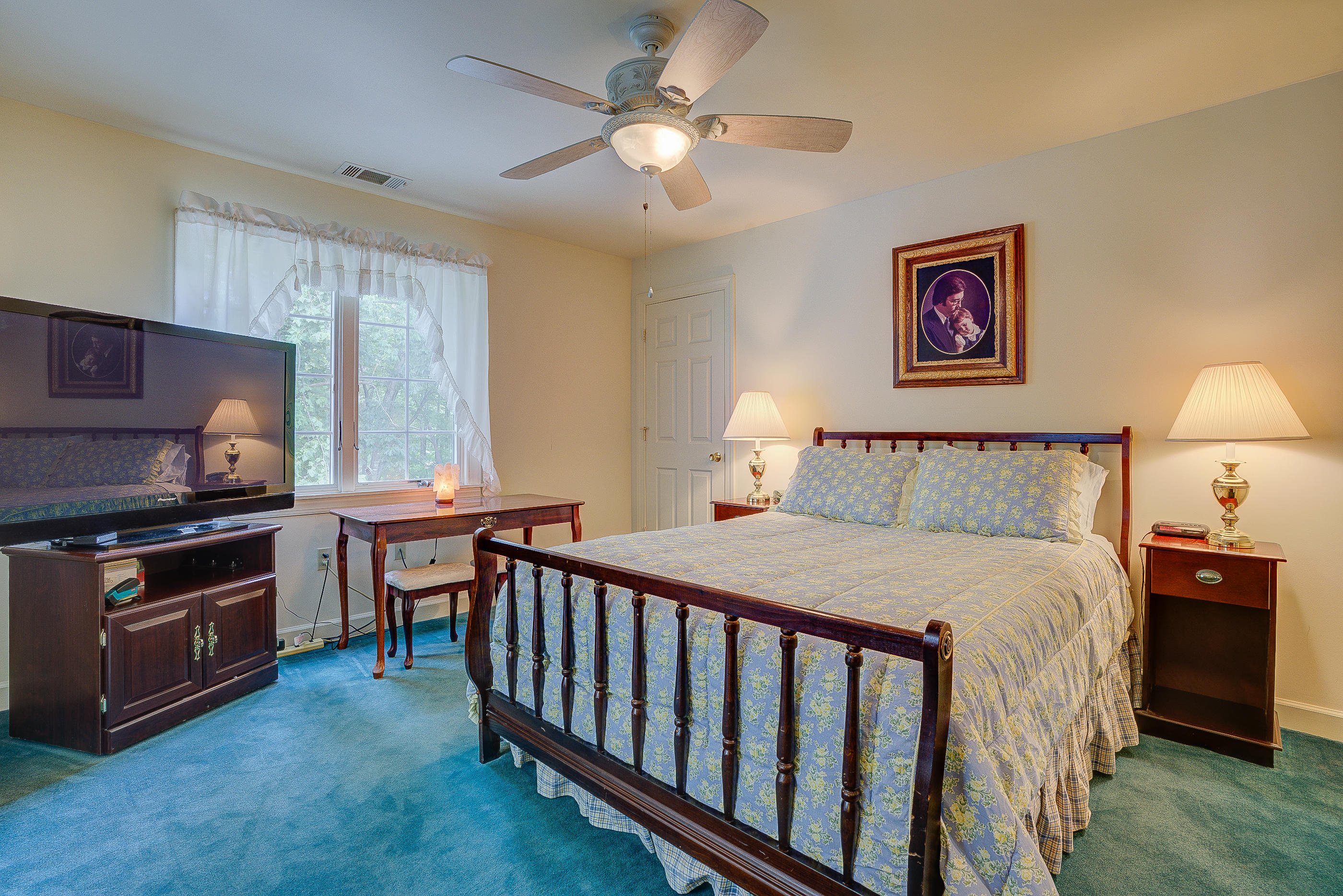 105 River Road North Covington, VA 24426 - Photo 36 of 77 a bedroom with a bed and a chandelier