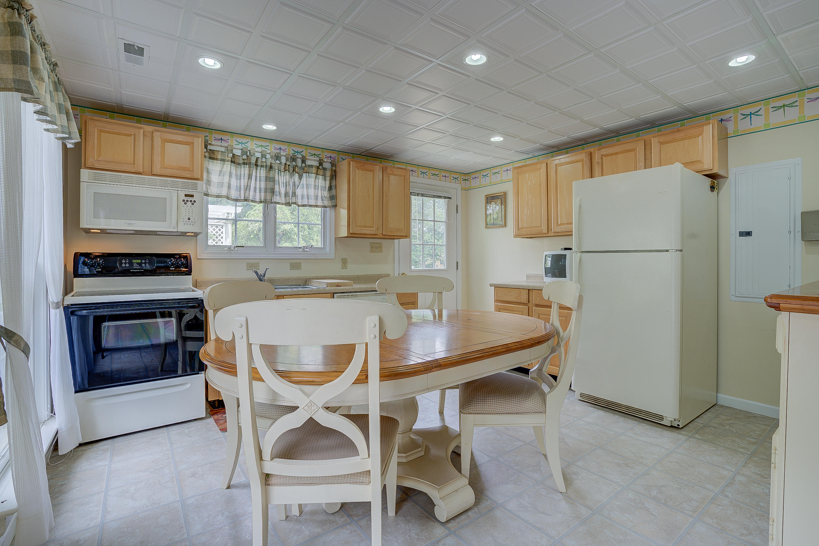 105 River Road North Covington, VA 24426 - Photo 63 of 77 a kitchen with a table chairs refrigerator and cabinets