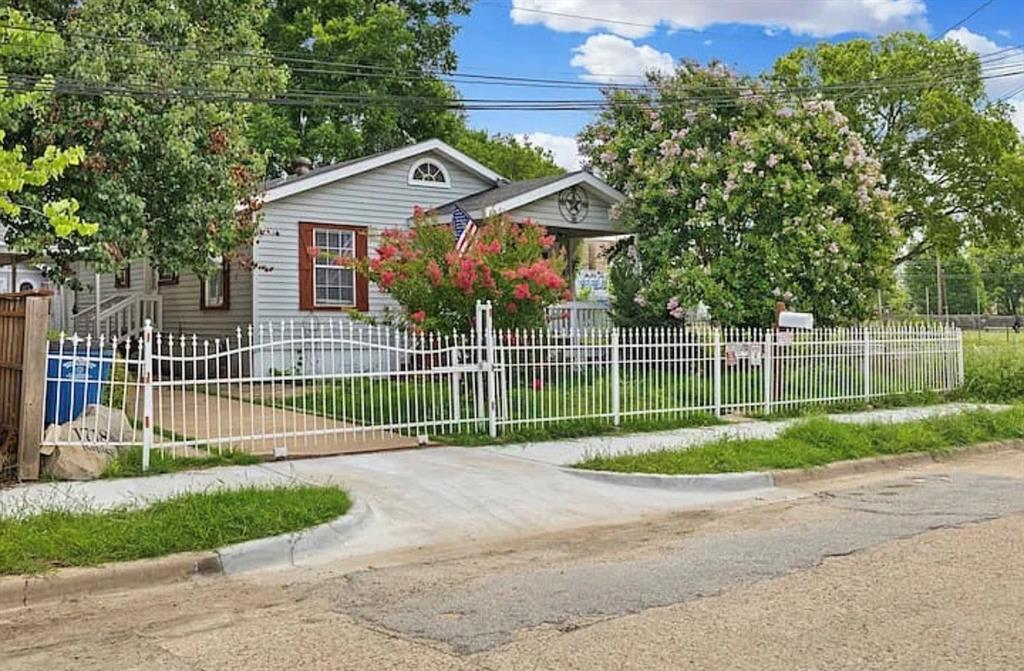 1718 Ripley Street Dallas, TX 75204 - Photo 29 of 33 Siding exterior featuring a front porch, white picket fencing, and mature landscaping