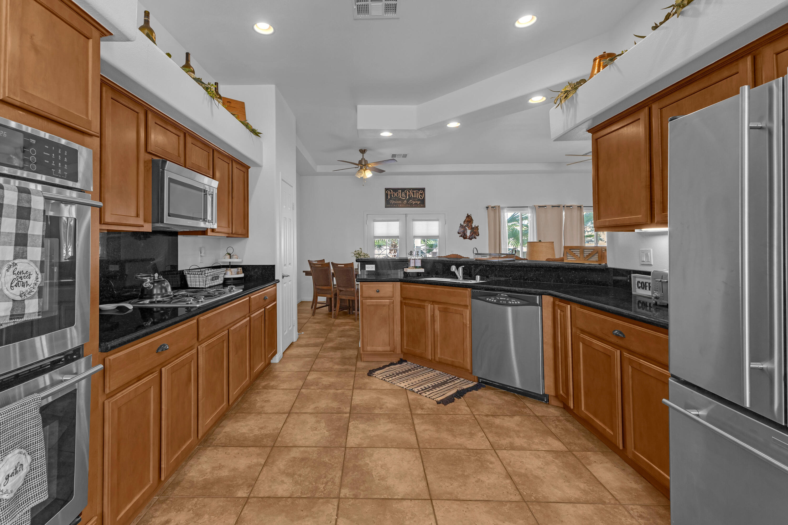 48305 Pic Way Indio, CA 92201 - Photo 11 of 77 a large kitchen with stainless steel appliances granite countertop a stove a sink dishwasher and a refrigerator