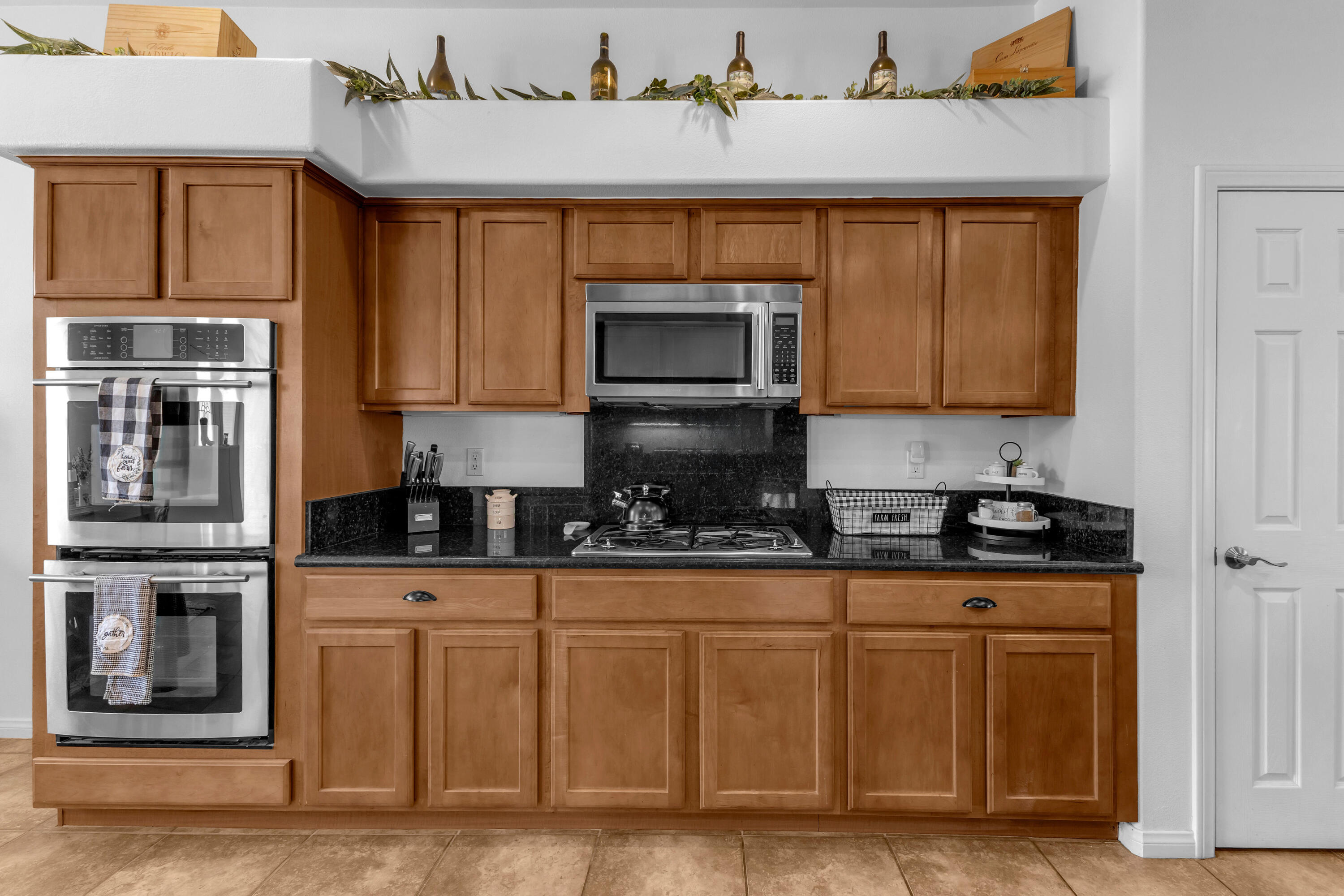 48305 Pic Way Indio, CA 92201 - Photo 14 of 77 a kitchen with stainless steel appliances granite countertop a stove and cabinets