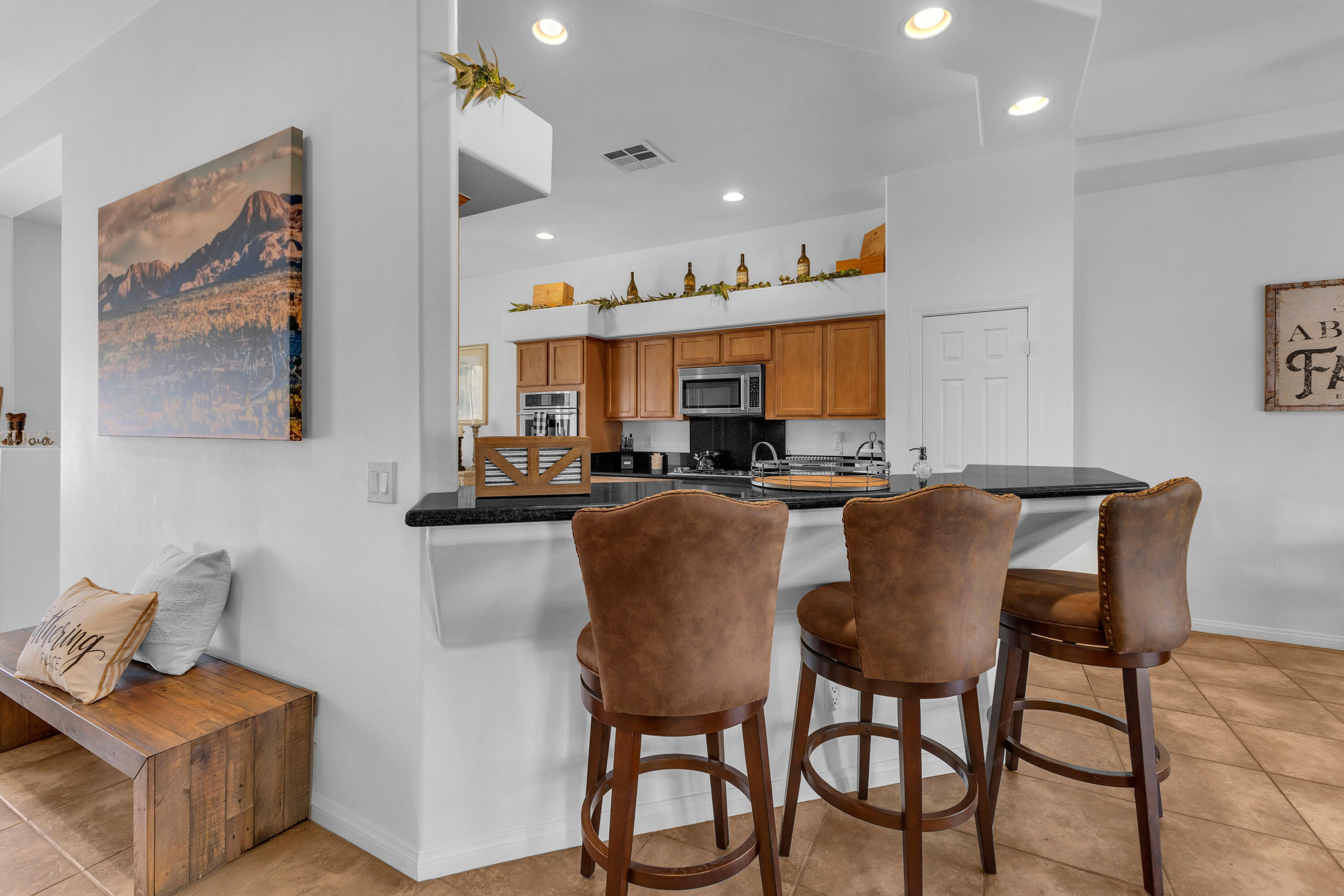 48305 Pic Way Indio, CA 92201 - Photo 18 of 77 a living room with stainless steel appliances furniture a rug and a kitchen view