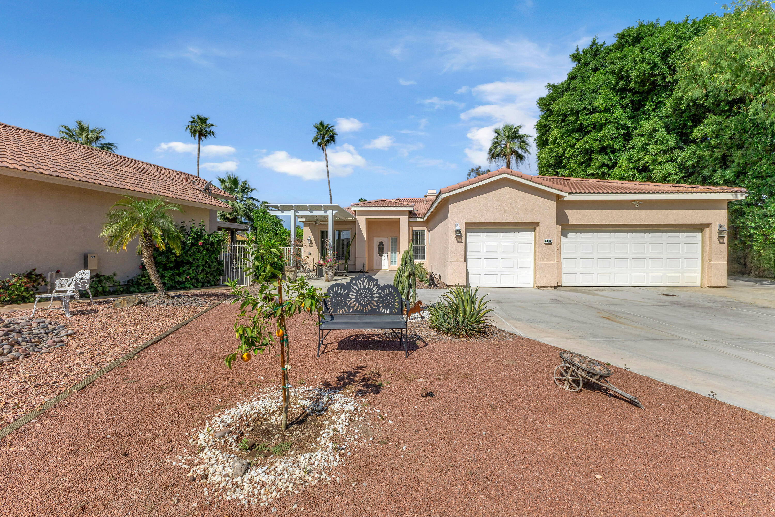 48305 Pic Way Indio, CA 92201 - Photo 2 of 77 a front view of a house with a yard and garage