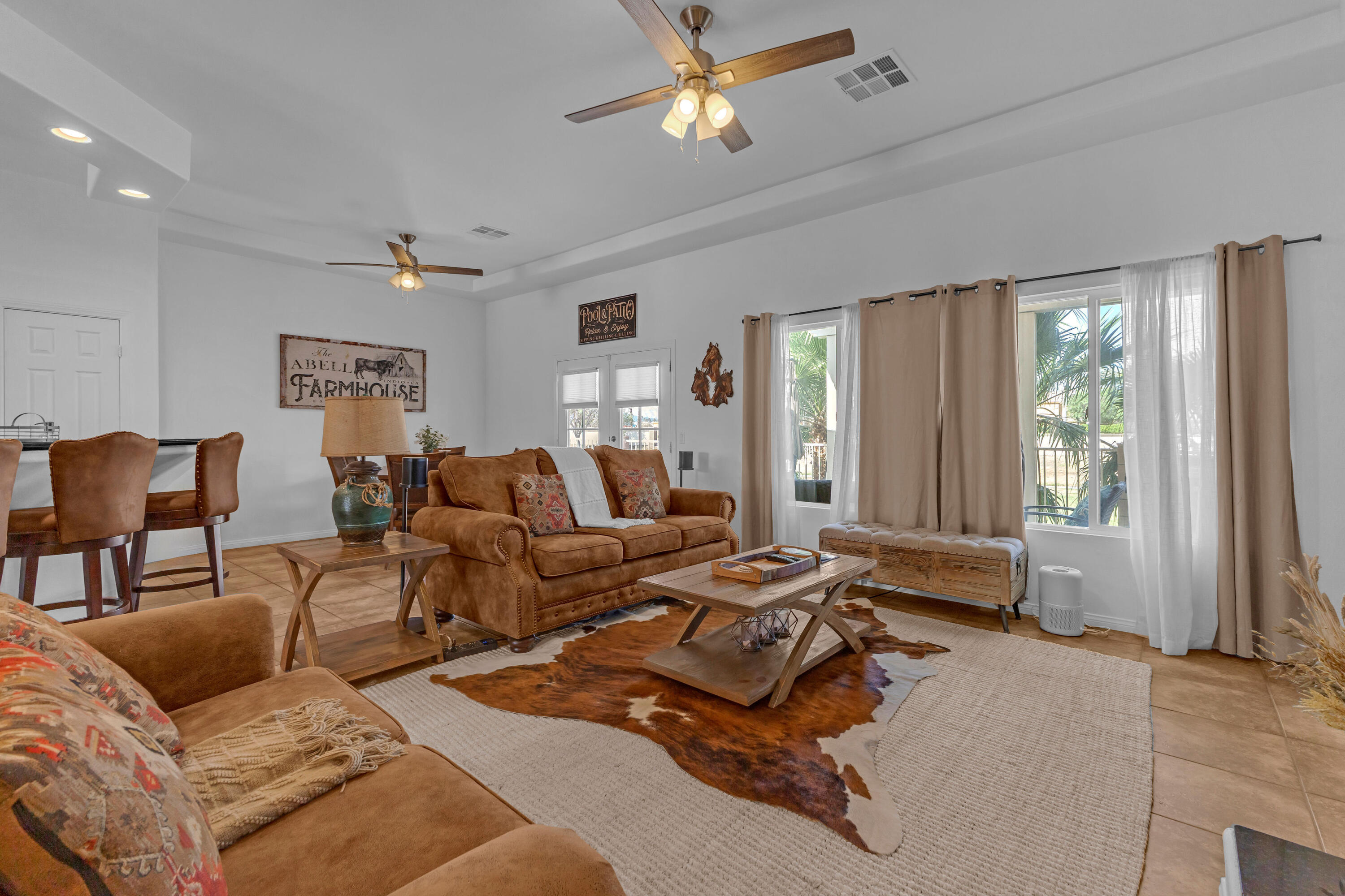 48305 Pic Way Indio, CA 92201 - Photo 21 of 77 a living room with furniture ceiling fan and a window