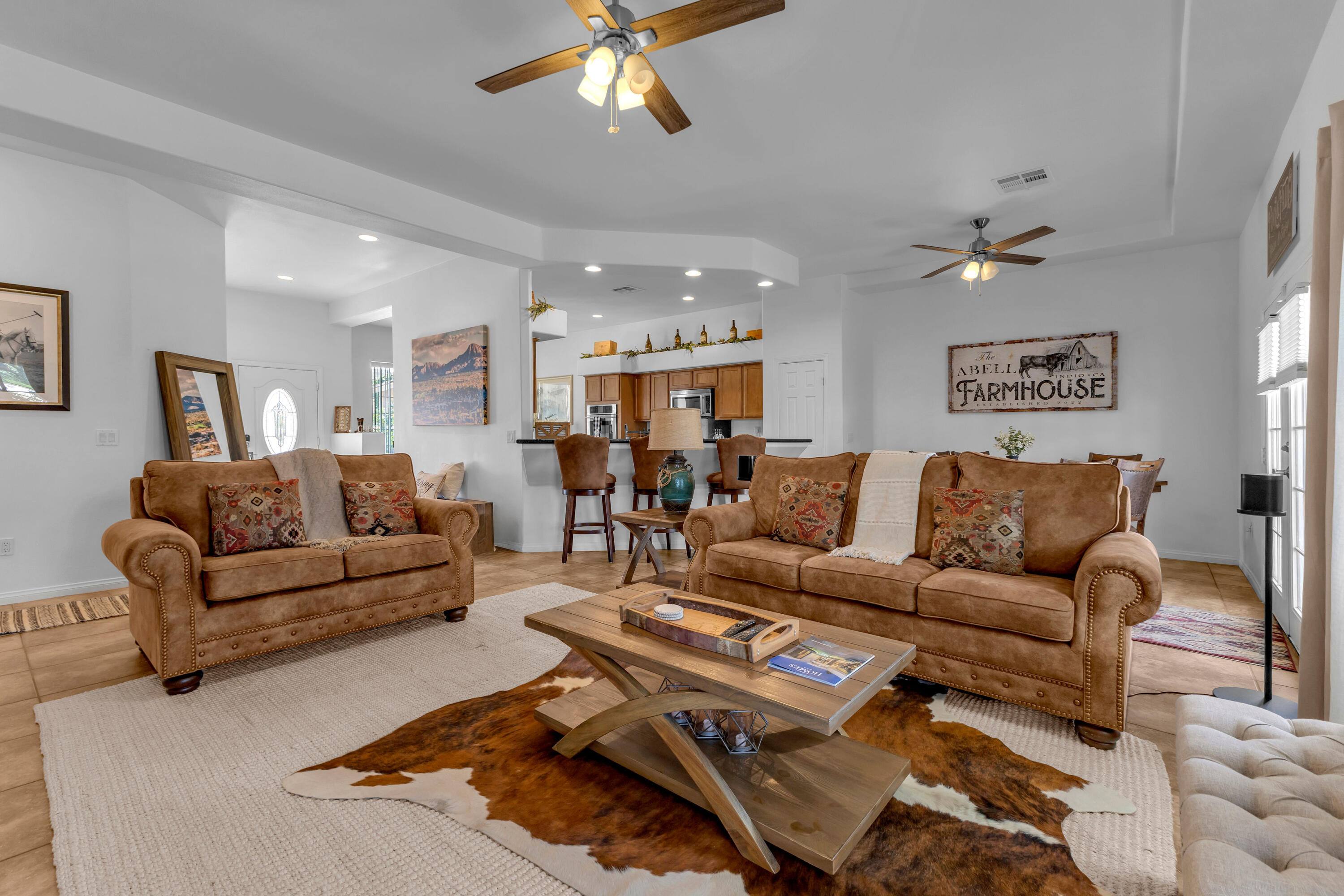 48305 Pic Way Indio, CA 92201 - Photo 23 of 77 a living room with furniture a chandelier and a dining room