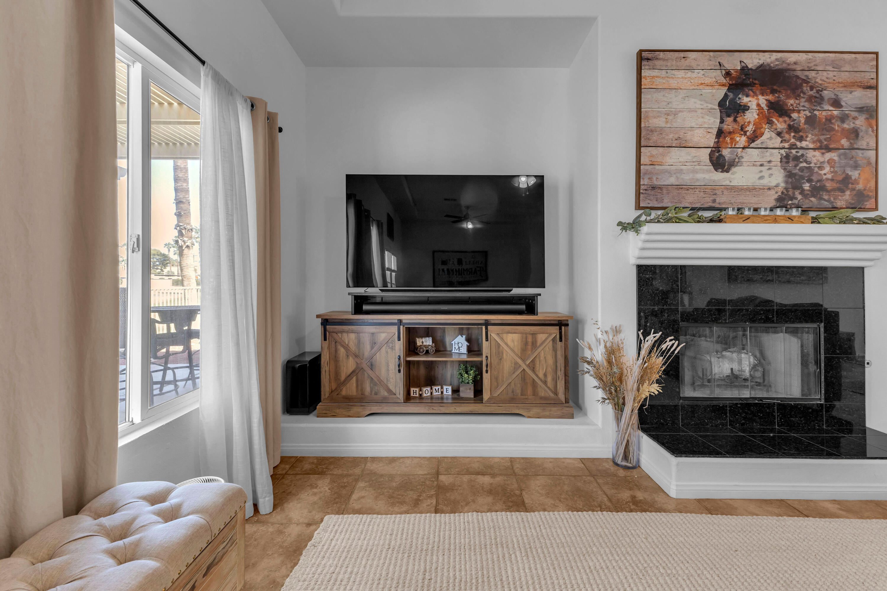 48305 Pic Way Indio, CA 92201 - Photo 25 of 77 a living room with a fireplace and a flat screen tv