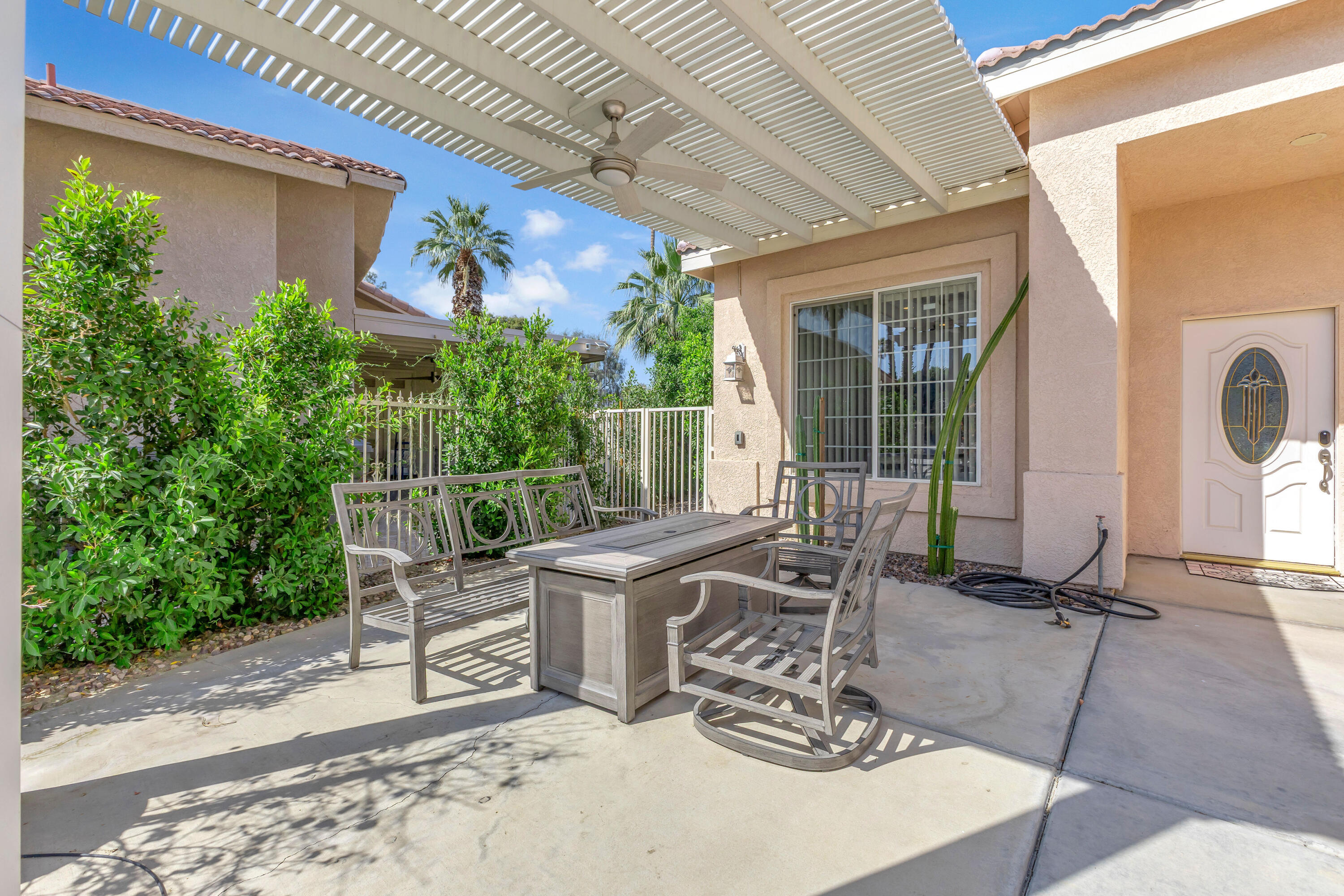 48305 Pic Way Indio, CA 92201 - Photo 5 of 77 a view of a patio with table and chairs and potted plants