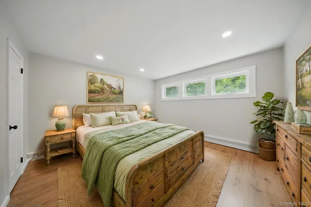 a bedroom with a bed and a potted plant