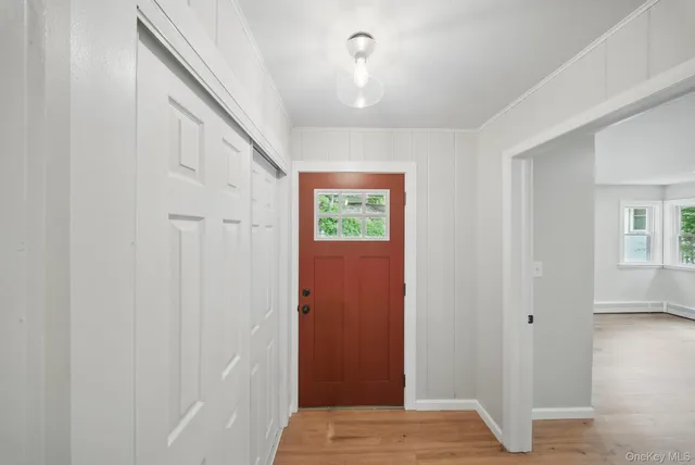 a view of an entryway with wooden floor