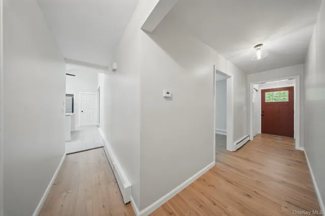 a view of hallway with wooden floor