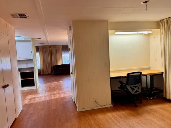 a view of kitchen with furniture and a refrigerator