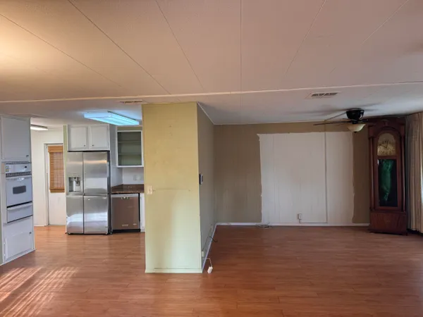 a view of empty room with wooden floor