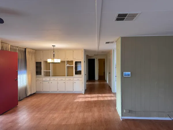a view of a refrigerator in kitchen and wooden floor