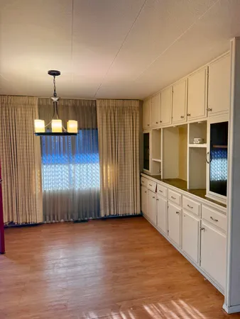 a kitchen with granite countertop a oven a cabinets and wooden floors