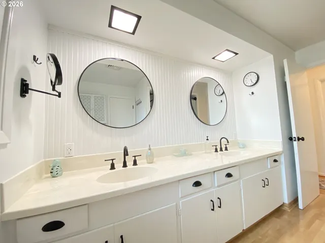 a bathroom with a double vanity sink and a mirror
