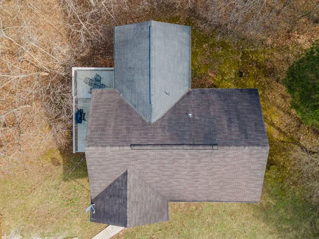 a backyard of a house with table and chairs