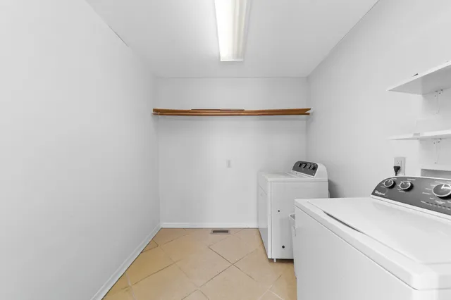 a view of a workspace with furniture and wooden floor