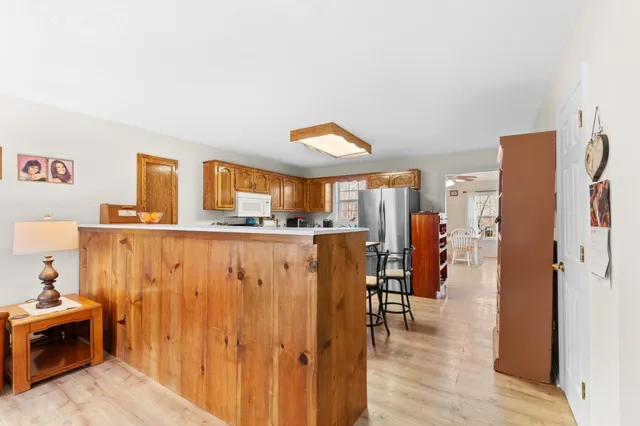 a view of kitchen with stainless steel appliances granite countertop cabinets and a refrigerator