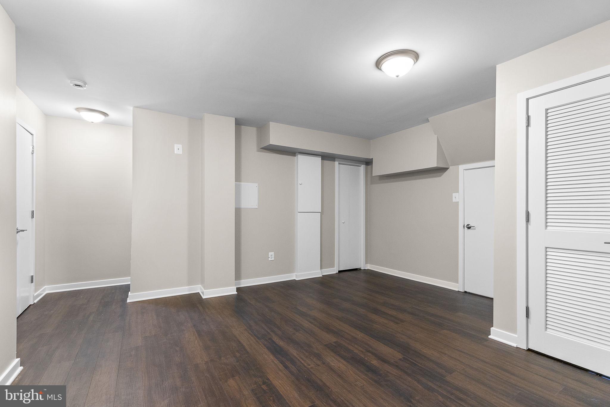 2050 Golf Course Drive Reston, VA 20191 - Photo 30 of 40 an empty room with wooden floor and windows