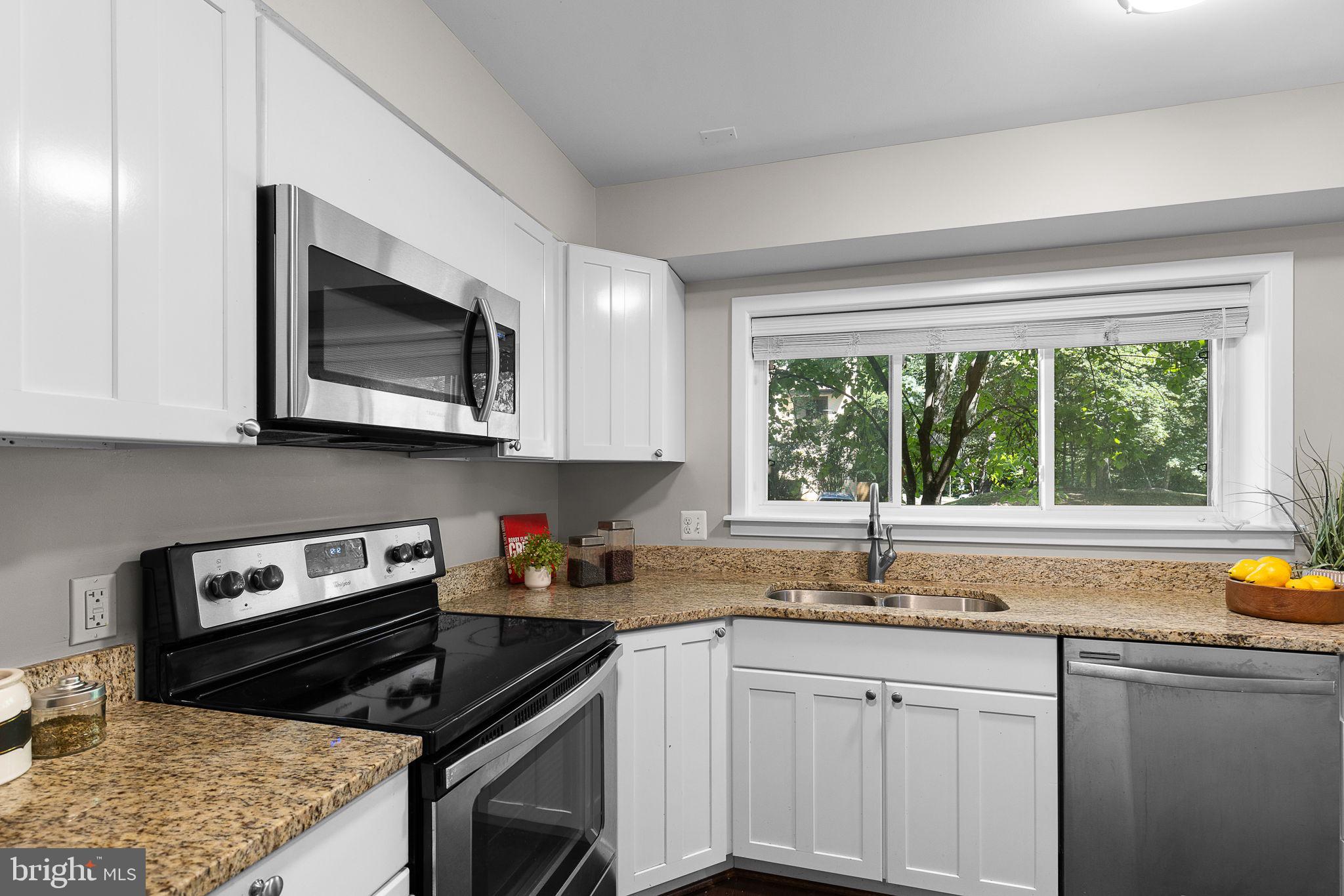 2050 Golf Course Drive Reston, VA 20191 - Photo 8 of 40 a kitchen with granite countertop a stove sink and microwave