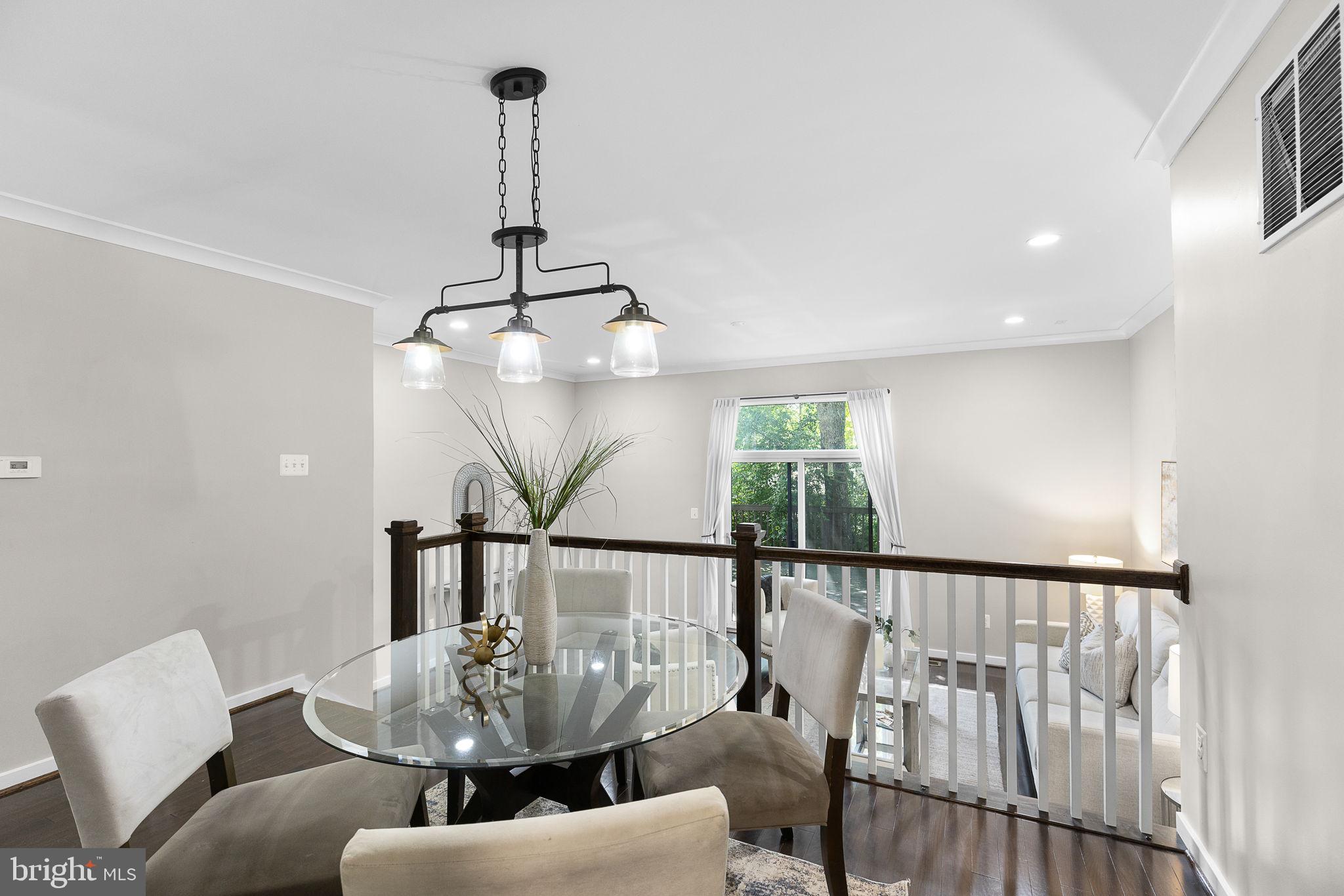 2050 Golf Course Drive Reston, VA 20191 - Photo 10 of 40 a dining room with furniture a chandelier and window
