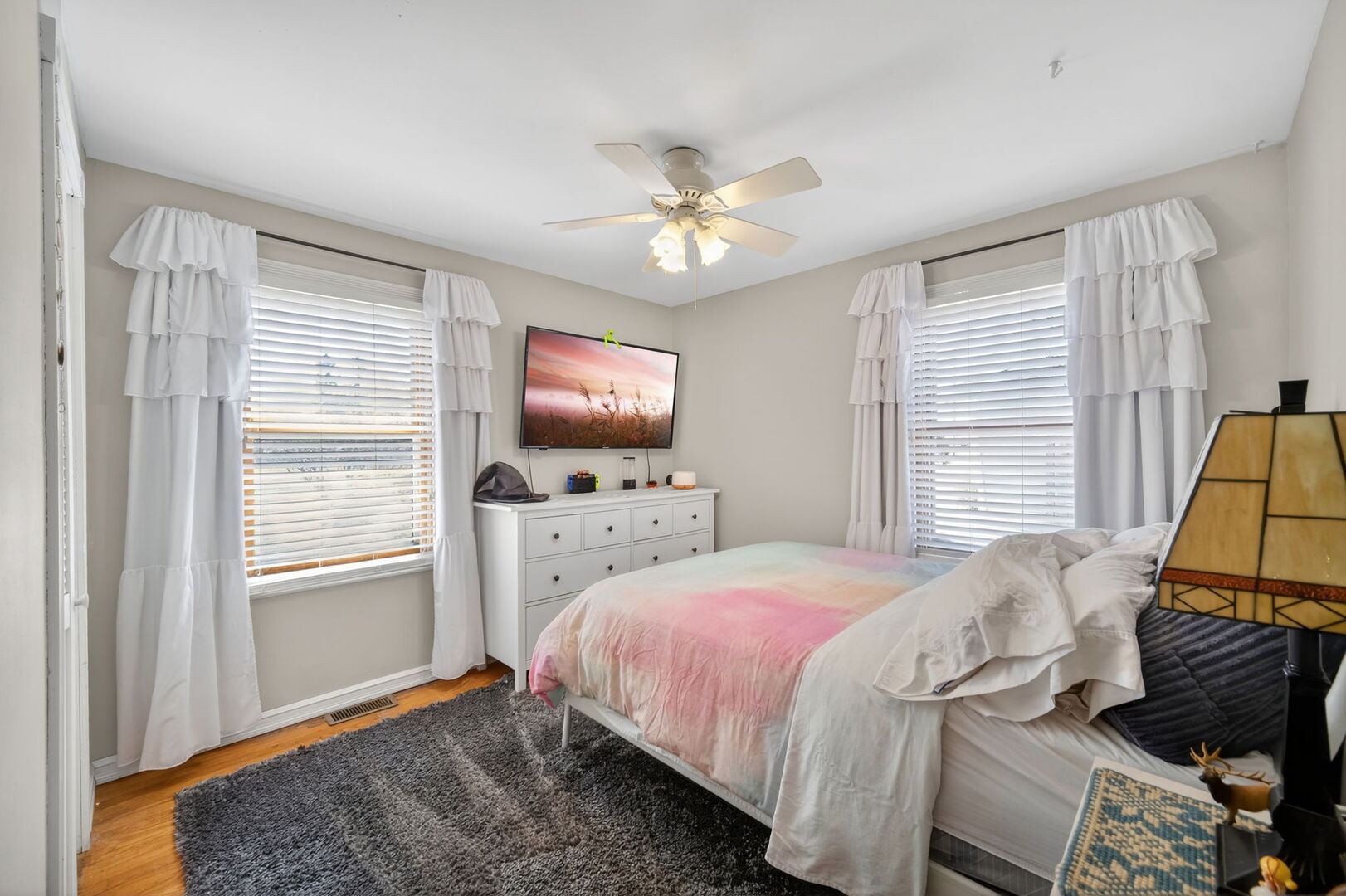 407 Butterfield Road North Aurora, IL 60542 - Photo 16 of 50 a bedroom with a bed furniture and a flat screen tv