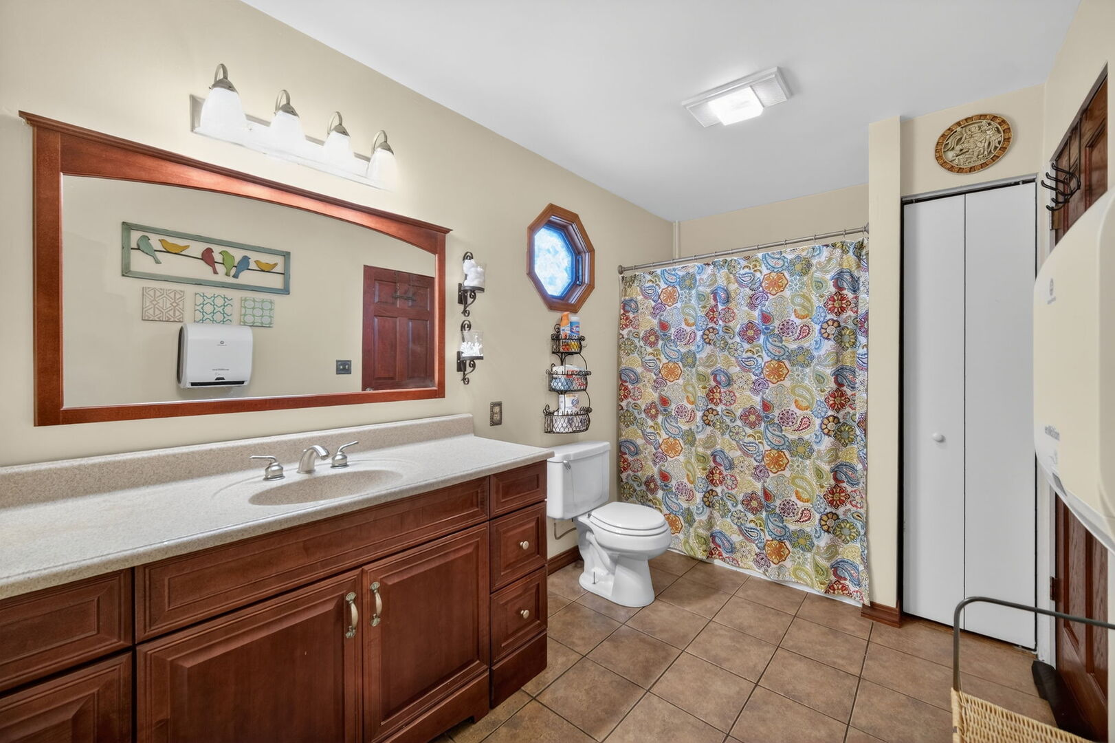 407 Butterfield Road North Aurora, IL 60542 - Photo 19 of 50 a bathroom with a sink a toilet a mirror and shower curtain