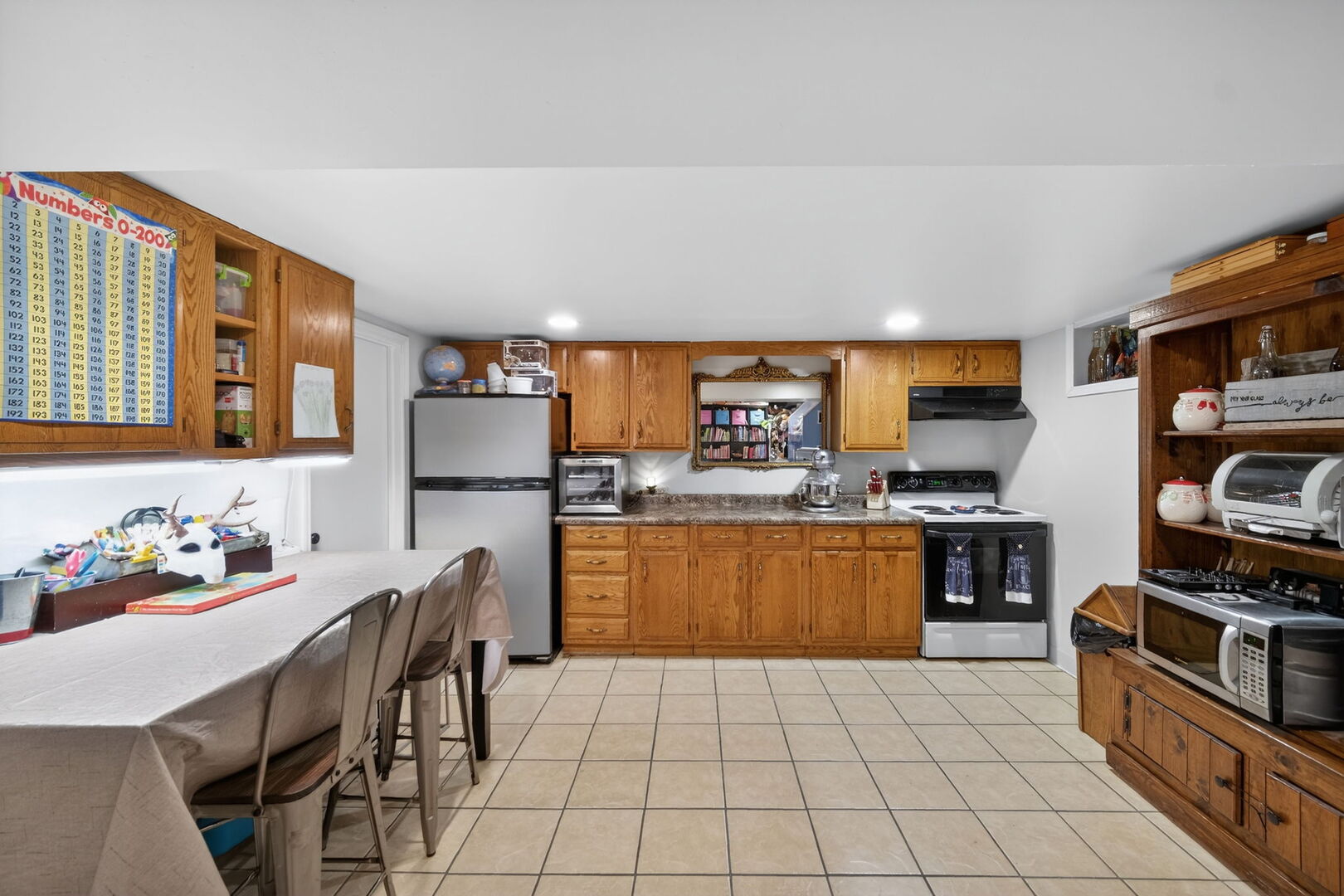 407 Butterfield Road North Aurora, IL 60542 - Photo 26 of 50 a kitchen with stainless steel appliances a refrigerator a stove a sink a dining table and chairs