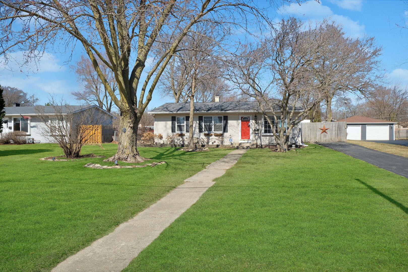 407 Butterfield Road North Aurora, IL 60542 - Photo 4 of 50 a front view of a building with a garden
