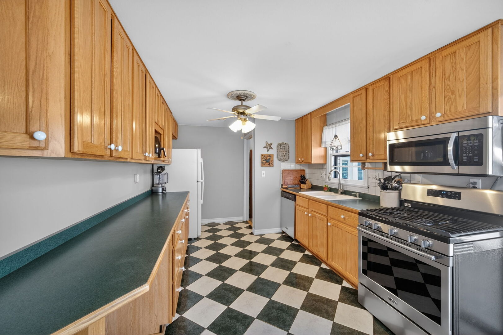 407 Butterfield Road North Aurora, IL 60542 - Photo 9 of 50 a kitchen with stainless steel appliances a stove a sink and a microwave