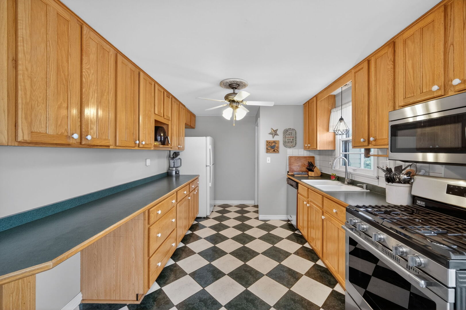 407 Butterfield Road North Aurora, IL 60542 - Photo 10 of 50 a kitchen with stainless steel appliances a stove a sink and a microwave