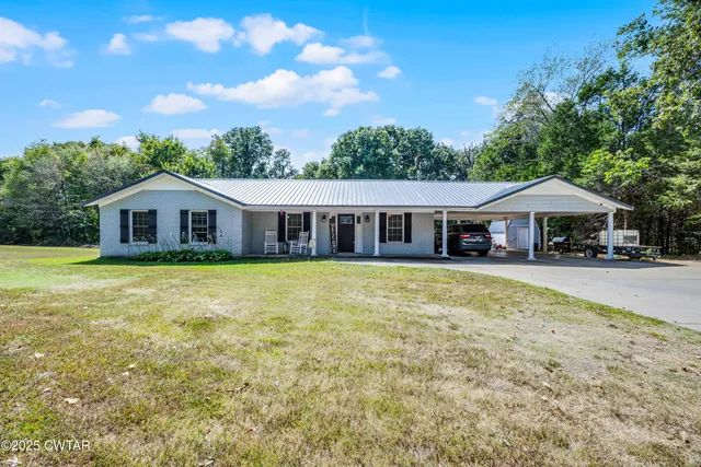 a front view of house with yard outdoor seating and barbeque oven