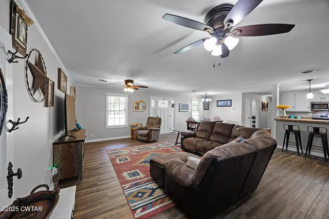 a living room with furniture and a chandelier