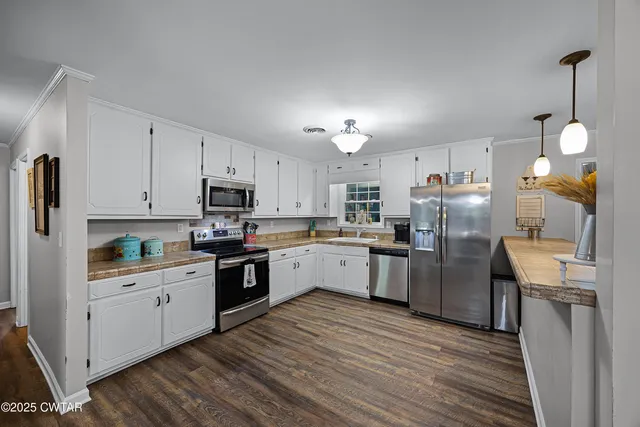 a kitchen with cabinets and stainless steel appliances