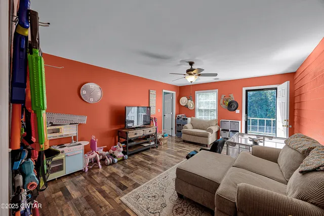a living room with furniture and a flat screen tv