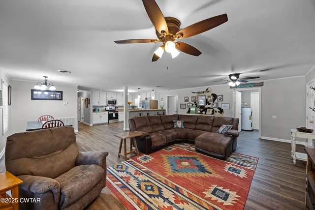 a living room with furniture and a wooden floor