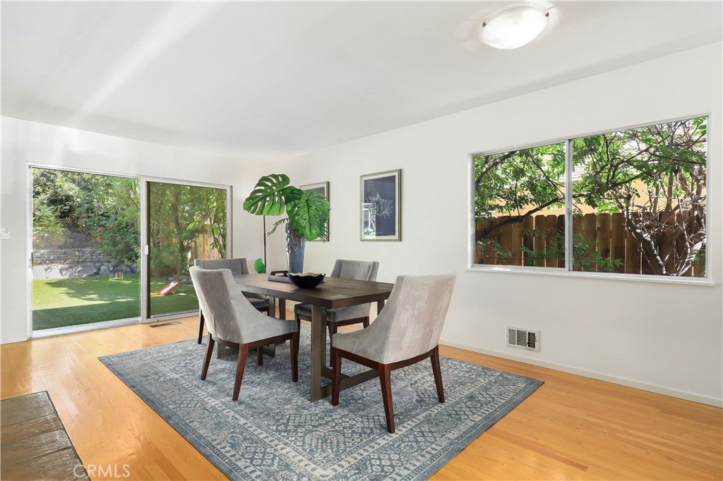 1237 Olive Lane La Canada Flintridge, CA 91011 - Photo 12 of 57 a view of a dining room with furniture wooden floor and garden view