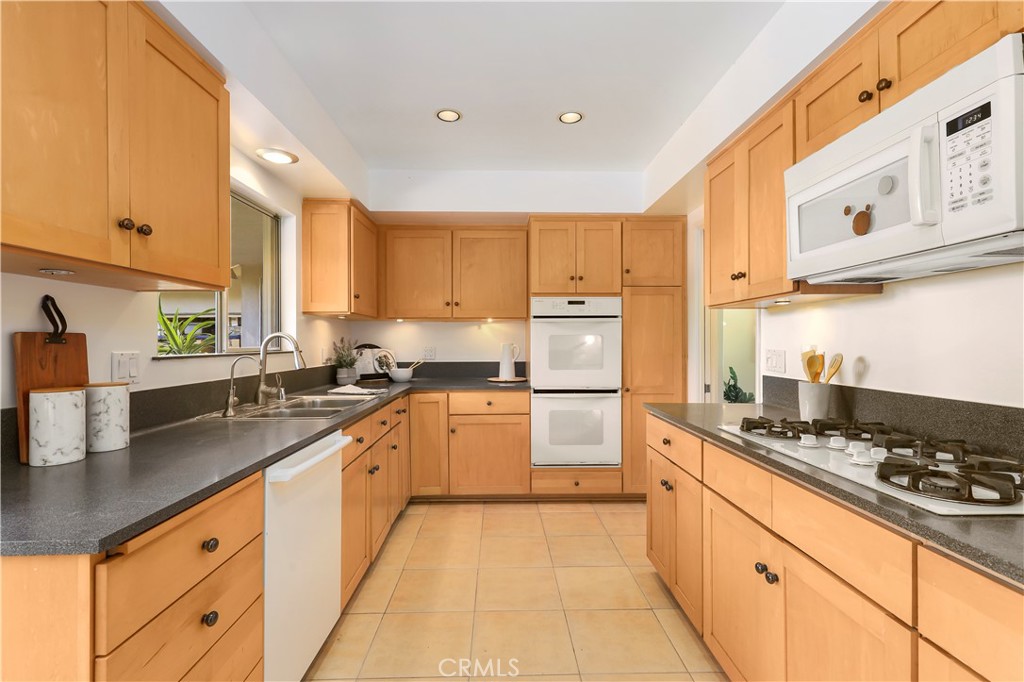 1237 Olive Lane La Canada Flintridge, CA 91011 - Photo 22 of 57 a kitchen with stainless steel appliances granite countertop a sink stove and refrigerator