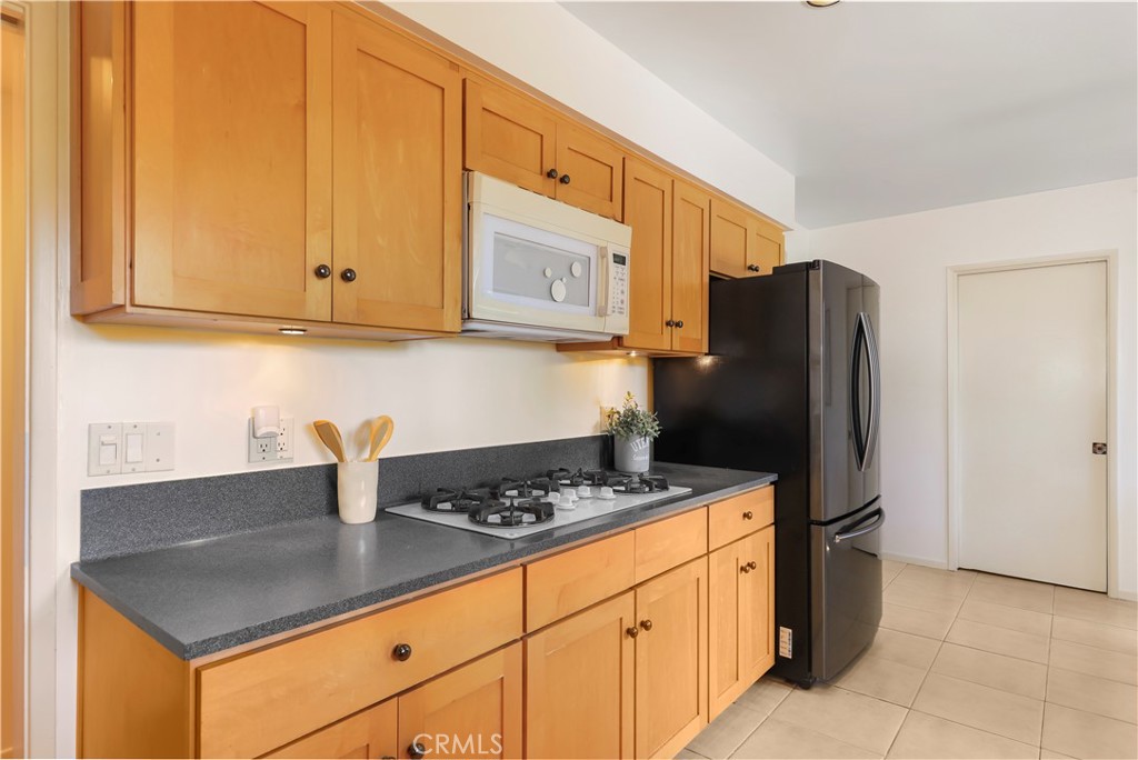 1237 Olive Lane La Canada Flintridge, CA 91011 - Photo 24 of 57 a kitchen with stainless steel appliances granite countertop a stove a refrigerator and a cabinets